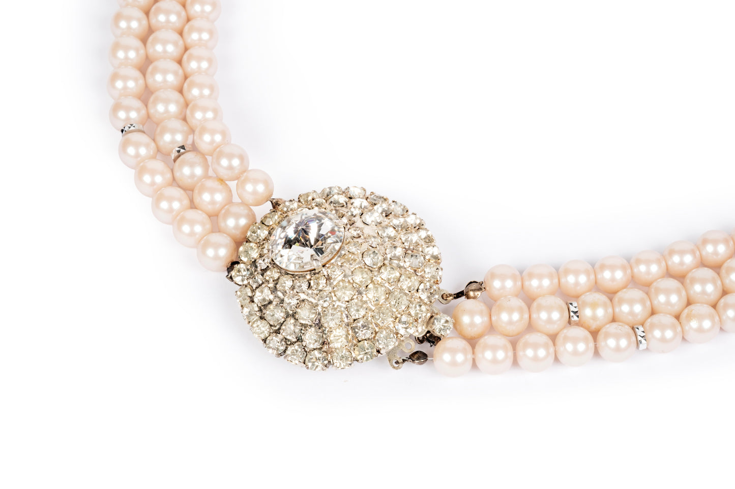 Three-strand pink pearl necklace with crystal center