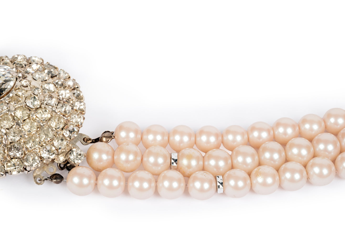Three-strand pink pearl necklace with crystal center