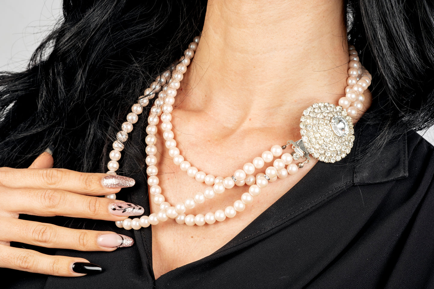 Three-strand pink pearl necklace with crystal center
