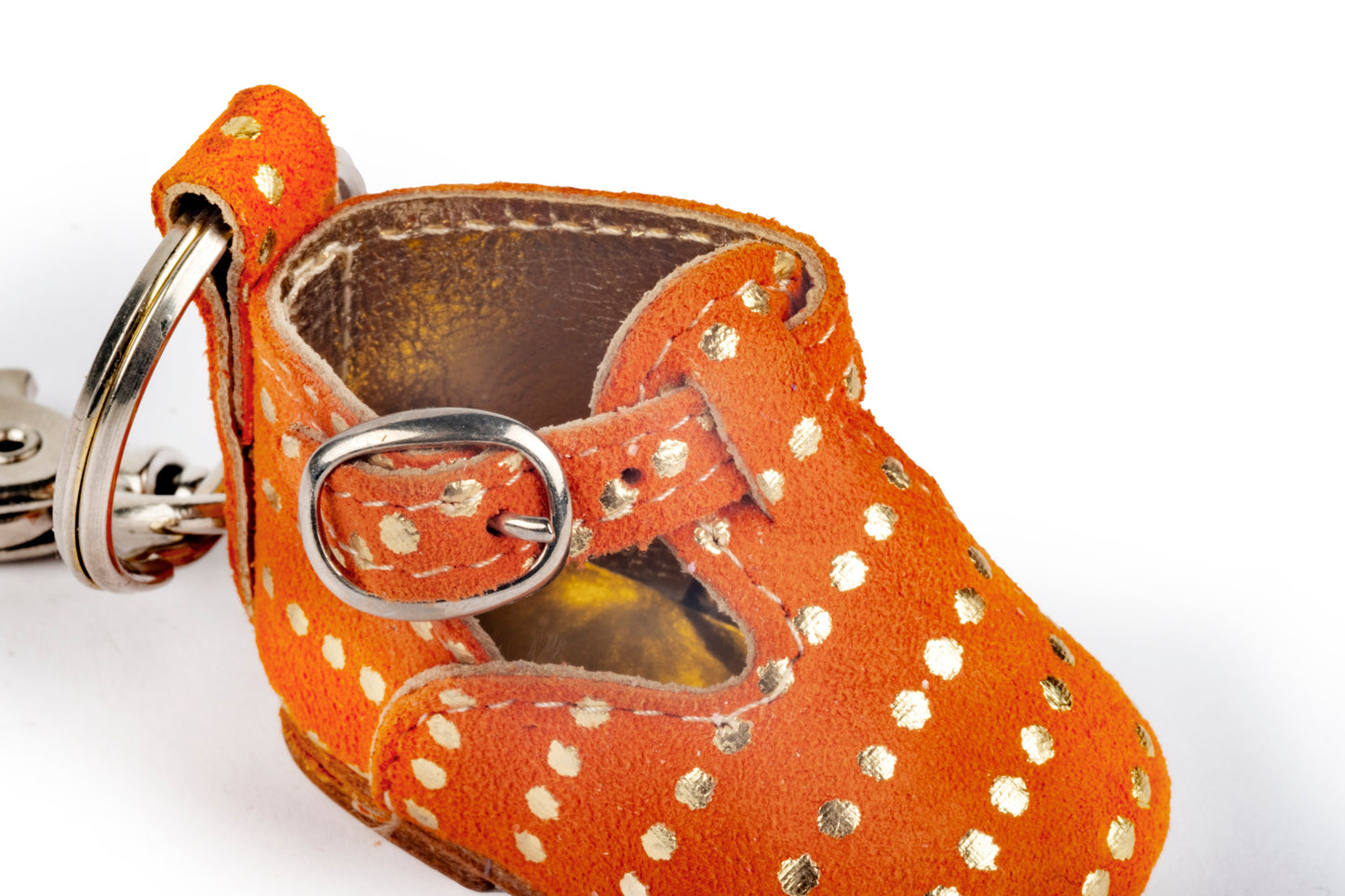 Orange baby shoe keychain with gold polka dots