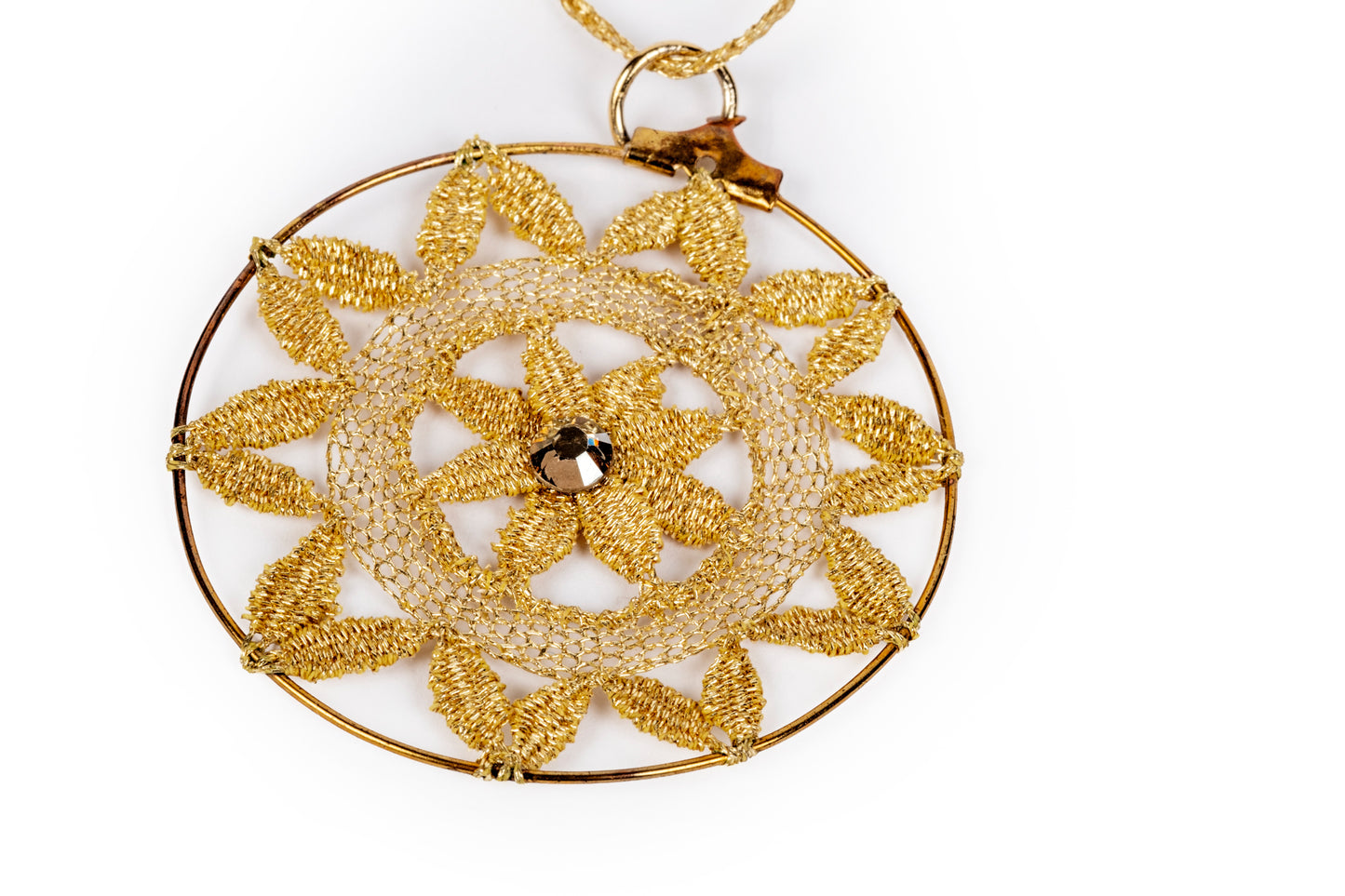 Bobbin lace pendant in metallic gold with a sparkling detail